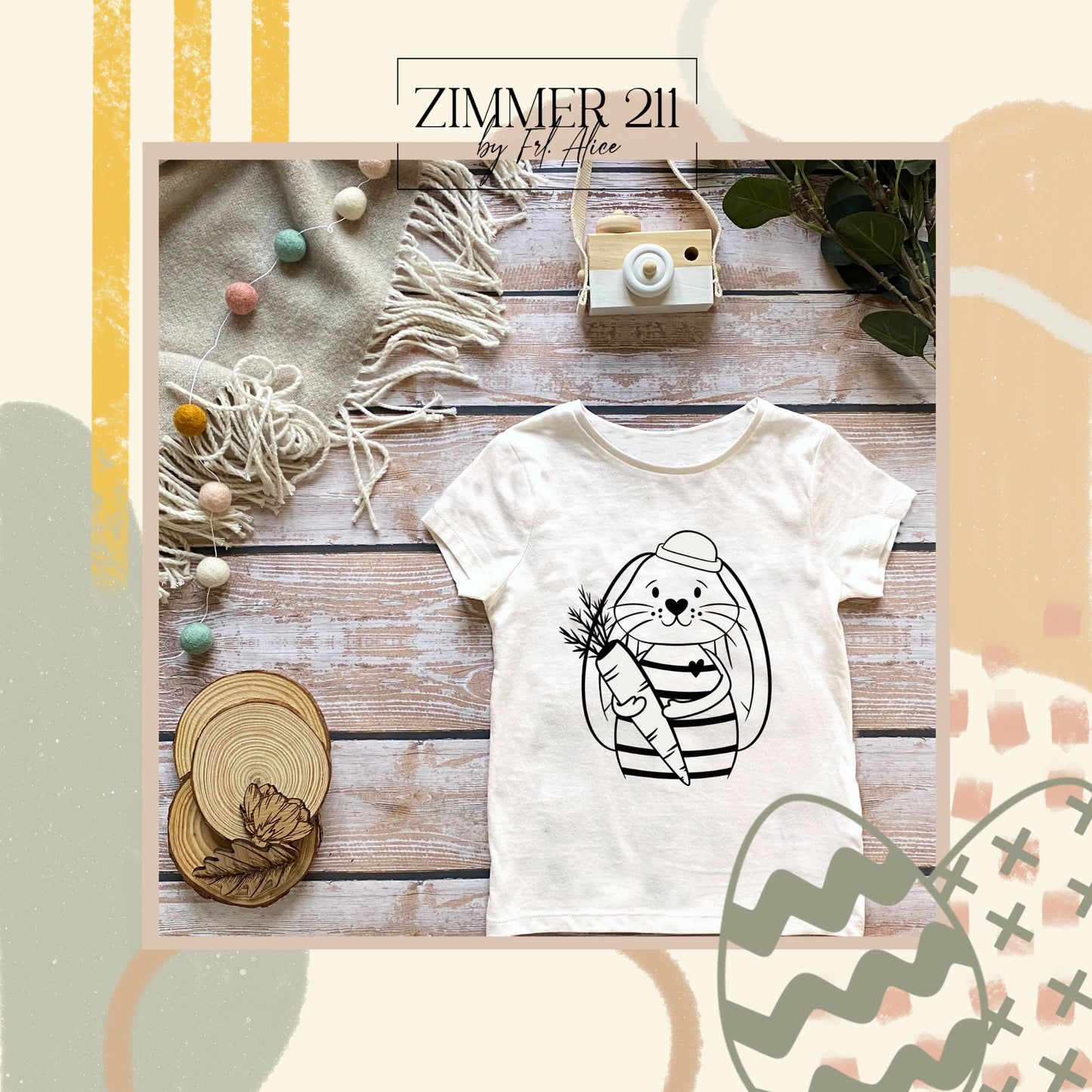 Personalisierte Kindermode: Weißes Baby-T-Shirt mit einem aufgebügelten Hasen-Motiv, der eine Karotte hält und eine Mütze trägt.